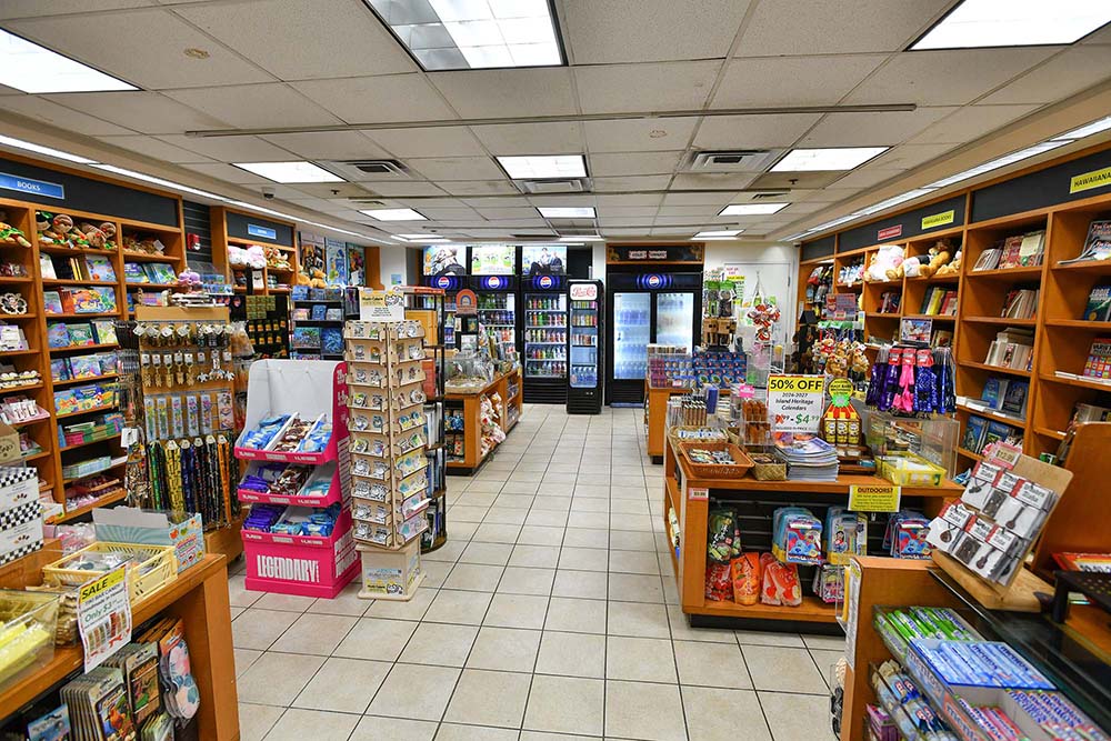 Inside one of Blind Vendors Ohana's airport convenience stores, with shelves of snacks, reading material, and Hawaiʻi-made goods.